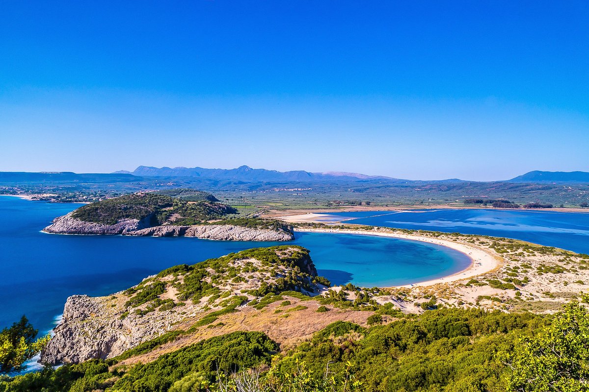 Aerial view of Voidokilia Beach with its iconic omega-shaped coastline and turquoise waters in Messinia, Greece